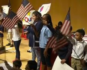 Students act out their essay in a class skit