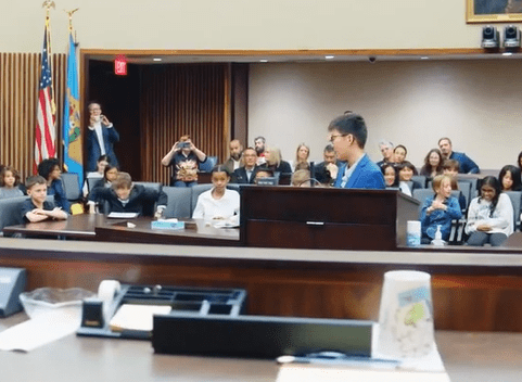 Student at podium arguing a case in a mock trial.