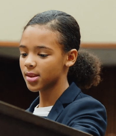 Young African-American woman speaking during mock trial.